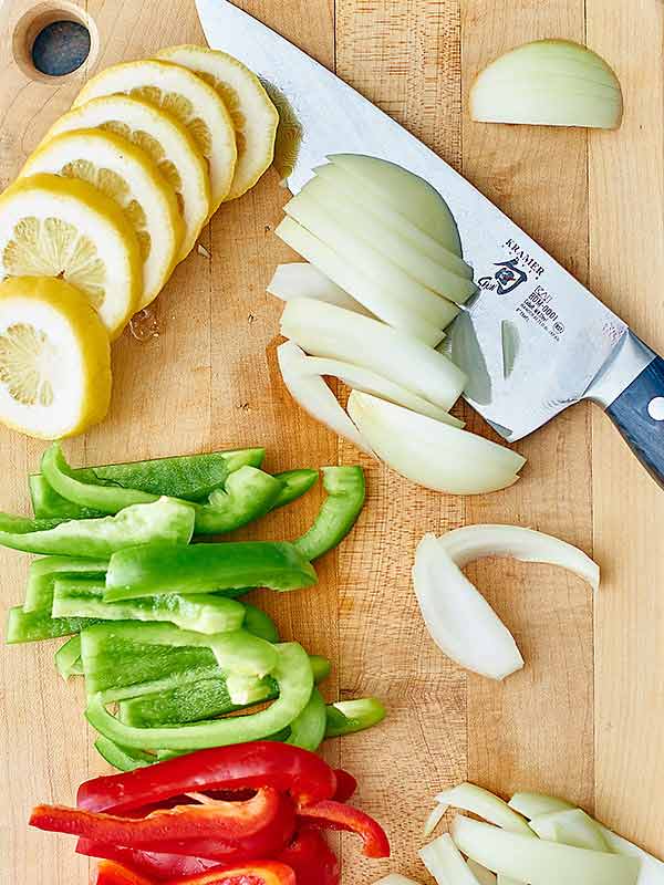 sliced fajita veggies on cutting board above