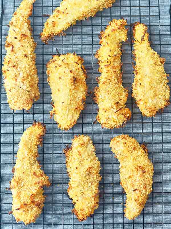 coconut chicken fingers on cooling rack above