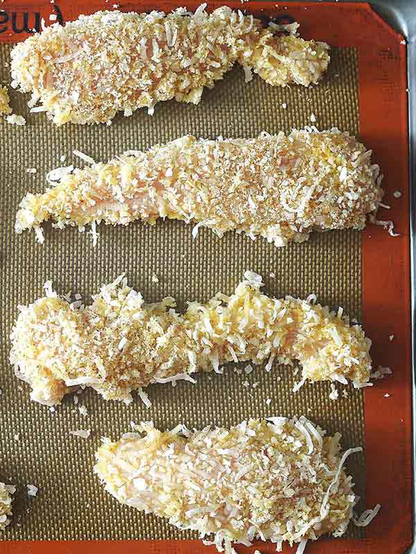 four chicken fingers on baking sheet above