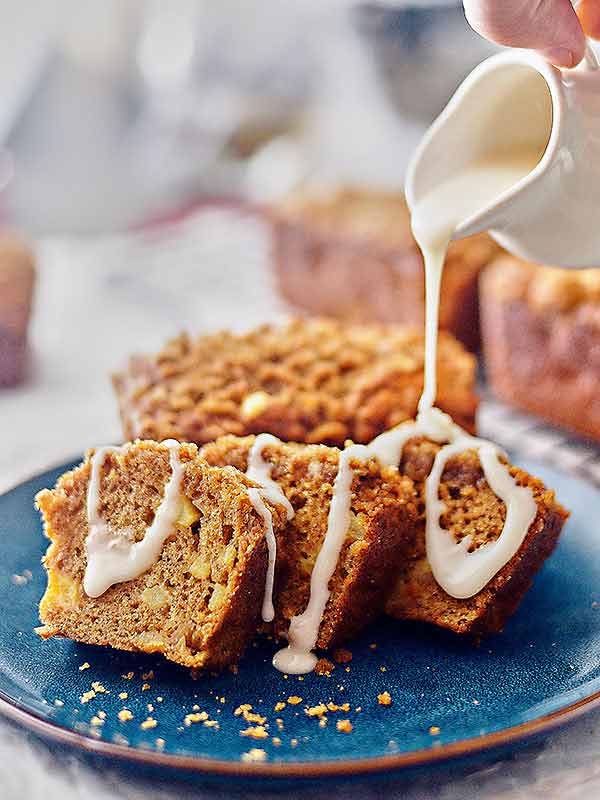 mini apple cake loaf slices on plate drizzled with icing