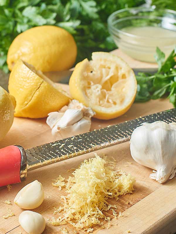 Cutting board with lemon pasta sauce ingredients