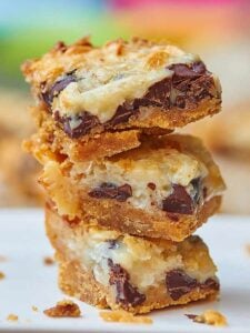 These ugly duckling bars may not be much to look at, but they sure taste good! Start with a graham cracker crust and pile on gooey chocolate chips, sweet coconut flakes, and sweetened condensed milk! www.showmetheyummy.com #bars #dessert #chocolatechips #coconut #sweetenedcondensedmilk
