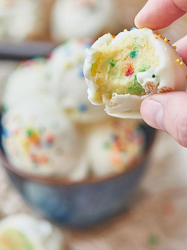 lemon funfetti cake ball with bite out held
