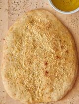 This parmesan herbed focaccia is slightly chewy, as focaccia should be, but it still has a nice golden crust and sooo soft on the inside. It's filled with garlic powder, thyme, oregano, and basil for a truly herby taste, and it's topped with salt and parmesan cheese for an extra salty kick! www.showmetheyummy.com #baking #bread #focaccia #parmesanfocaccia #herbedfocaccia