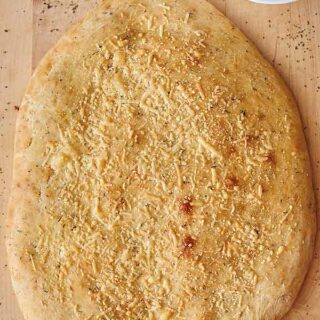 This parmesan herbed focaccia is slightly chewy, as focaccia should be, but it still has a nice golden crust and sooo soft on the inside. It's filled with garlic powder, thyme, oregano, and basil for a truly herby taste, and it's topped with salt and parmesan cheese for an extra salty kick! www.showmetheyummy.com #baking #bread #focaccia #parmesanfocaccia #herbedfocaccia
