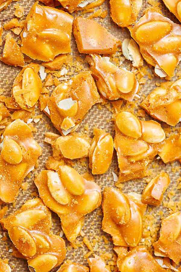 pieces of pumpkin seed brittle on baking sheet above