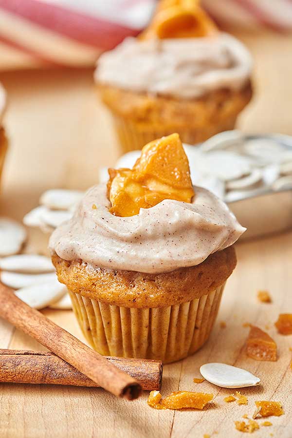 These pumpkin cupcakes with cinnamon cream cheese frosting and pumpkin seed brittle are a seriously impressive dessert that you can feel SO proud of serving at your next event! A soft, delicate cupcake that's filled with pumpkin and spices, a cool, thick, cinnamon cream cheese frosting, and to top it off? A crunchy, sweet and salty pumpkin seed brittle. They're easy enough to make every week, but fancy enough to serve to impress! https://showmetheyummy.com #pumpkin #cupcakes #cinnamon #creamcheesefrosting #desserts #baking