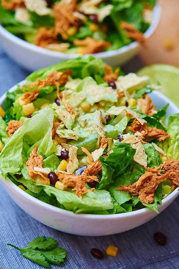 bbq chicken salad in bowl, another in background