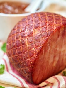 This ham with pineapple sauce is going to blow you away! The ham is so moist and salty and the sauce is just the right amount of sweet to contrast :) showmetheyummy.com #ham #dinner #christmas #holiday #pineapple #pineapplesauce