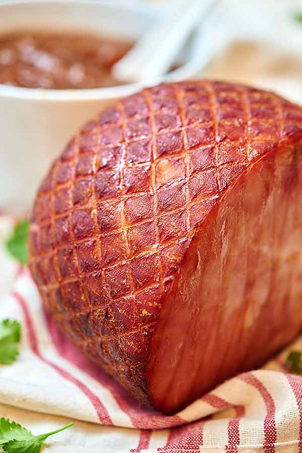 This ham with pineapple sauce is going to blow you away! The ham is so moist and salty and the sauce is just the right amount of sweet to contrast :) showmetheyummy.com #ham #dinner #christmas #holiday #pineapple #pineapplesauce