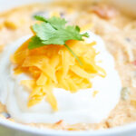 This crockpot jalapeno popper white chicken chili is exactly what you need for the Super Bowl! It’s so easy to make, so not messy, perfectly spicy, ridiculously creamy, and filled with chicken, jalapenos, beans, spices, and cream cheese! Can't you just picture enjoying this while watching the game? showmetheyummy.com #crockpot #slowcooker #chicken #chili #jalapenopopper