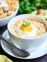 This crockpot jalapeño popper white chicken chili is exactly what you need for the Super Bowl! It’s so easy to make, so not messy, perfectly spicy, ridiculously creamy, and filled with chicken, jalapenos, beans, spices, and cream cheese! Can't you just picture enjoying this while watching the game? showmetheyummy.com #crockpot #slowcooker #chicken #chili #jalapenopopper