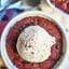 Just picture this with me, hot, chocolatey deep dish red velvet cookies for two with semi-sweet chocolate chips, fresh out of the oven, and topped with melty vanilla ice cream, and maybe drizzled with a little extra chocolate? Yes please! showmetheyummy.com #redvelvet #cookies #singleserving #dessert #chocolate