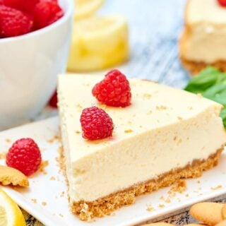 This light greek yogurt cream cheese cheesecake has decadence written all over it, but I love that it's lightened up! I promise you won't miss the full fat cream cheese and heavy sour cream. This cheesecake is light and fluffy, but still rich, has a very subtle lemony flavor and it won't leave you feeling guilty! showmetheyummy.com #cheesecake #greekyogurt