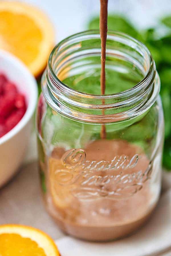 Smoothie being poured into mason jar