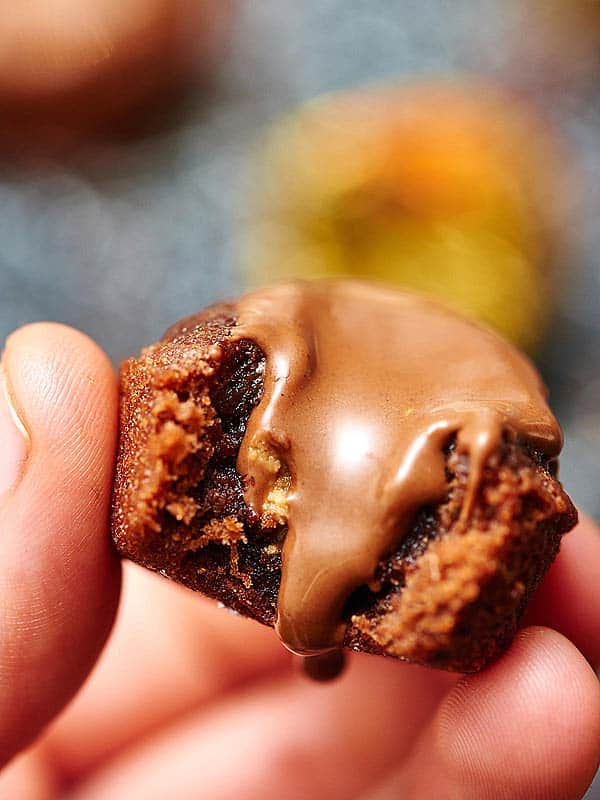 These peanut butter stuffed brownie bites are oogey gooey at it's finest! While these brownie bites would be great without the peanut butter cups, because they're so moist and fudgy, the Reese's really takes it to the next level! Biting into a rich, chewy brownie, and a melty peanut butter cup is pure heaven. showmetheyummy.com #brownies #dessert #browniebites #peanutbuttercup #reeses #stuffedbrownies #candy