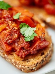 This sun dried and roma tomato bruschetta is truly flavorful and has amazing texture...I swear you won't believe it's healthy for you! I love the toasty crunch of the bread that's piled with two types of warm, juicy, tender tomatoes, spicy garlic, tangy balsamic, and sweet basil! showmetheyummy.com #bruschetta #tomato #healthy #vegan #vegetarian