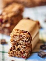 These dark chocolate chunk quinoa granola bars are so good! I love the crunch from the quinoa, and the oatmeal, almonds, and coconut get nice and roasty toasty in the oven and I mean, what better combination is there than dark chocolate and dried cherries? showmetheyummy.com #vegetarian #glutenfree #granola #granolabars #breakfast #snack #healthy