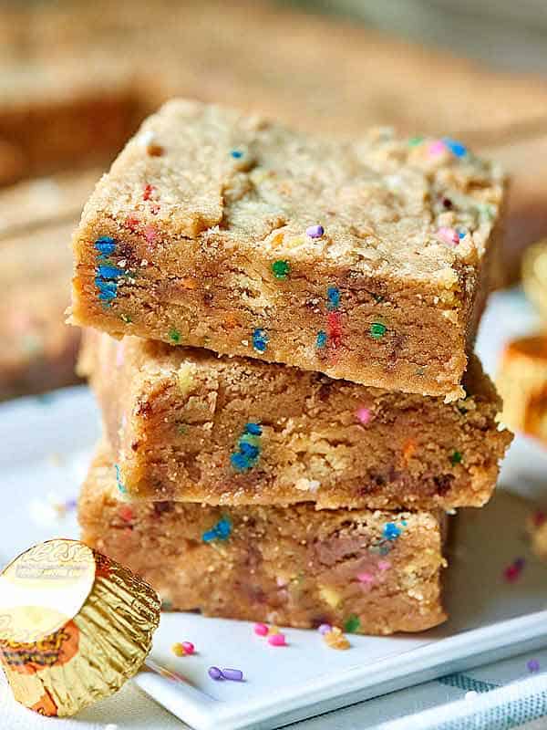 3 peanut butter blondies stacked on plate