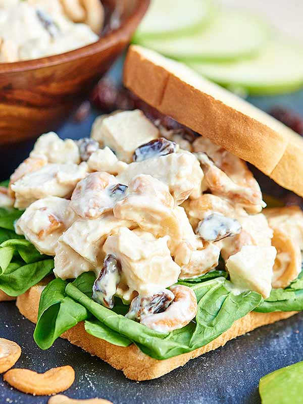 Greek yogurt chicken salad on a sandwich with spinach