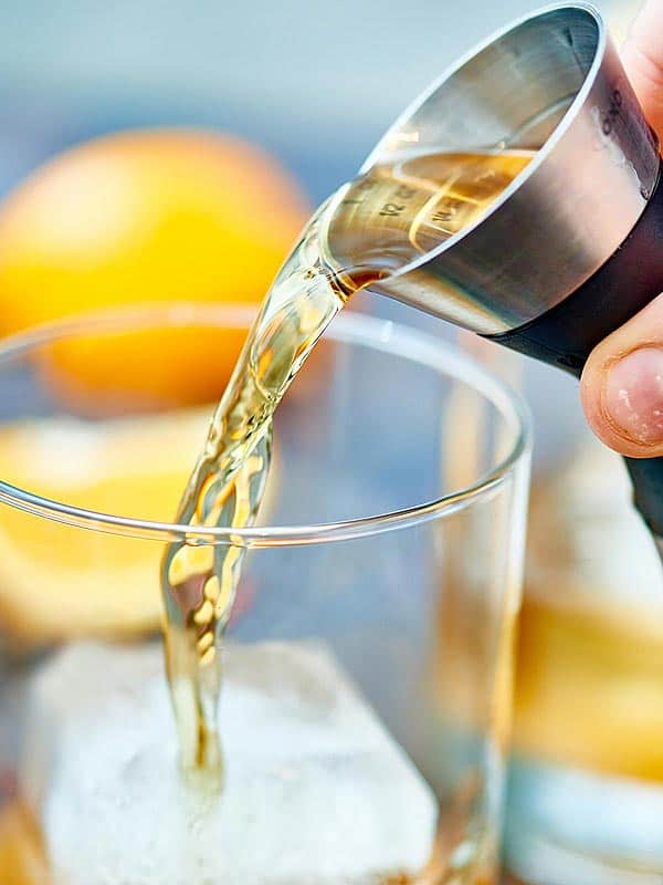 whiskey being poured into glass