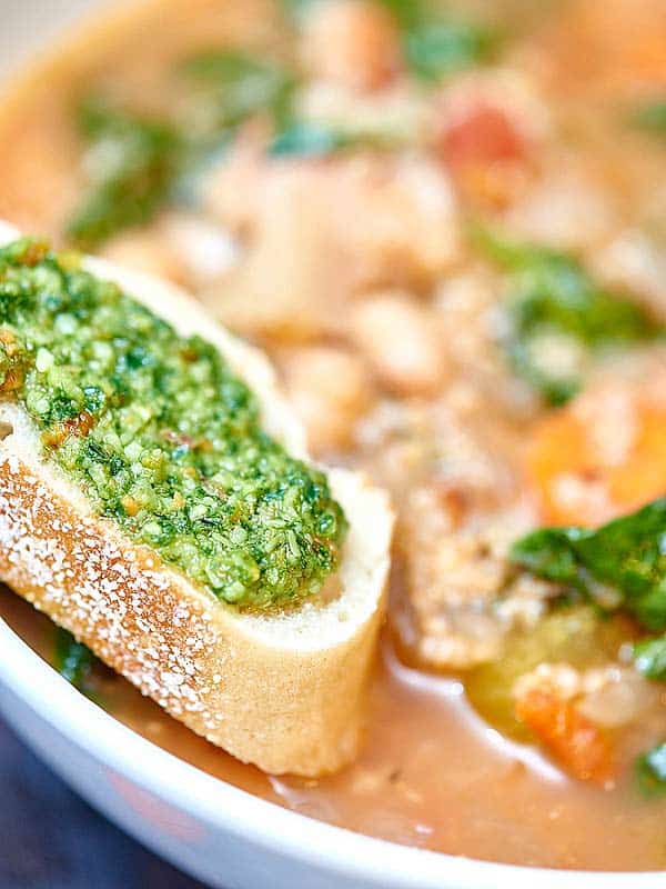 bread with pesto in bowl of soup