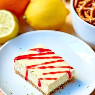 These tequila lime cheesecake bars are perfect for celebrating National Margarita Day! The slightly crunchy pretzel crust mimics the salty rim on a margarita and the cheesecake filling is so creamy and filled with cream cheese, lime juice, tequila, and grand mariner! It’s like eating your favorite margarita in bar form! ;) showmetheyummy.com #tequila #grandmariner #margarita #cheesecake #bars #pretzels #lime