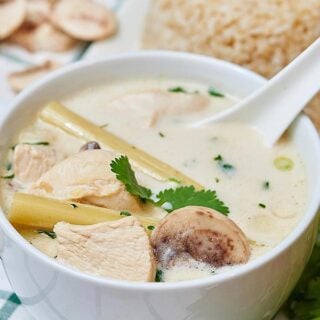 This Tom Kha Gai soup may not be 100% authentic, but I'd take this over take out any day! It's really easy to put together and it's a whole heckofalot cheaper than paying someone else to make it for you! This soup is a little limey, so creamy of the coconut milk, has a nice back heat from the cayenne, and is full of tender chicken! showmetheyummy.com #tomkhagai #soup #coconut #chicken #coconutchickensoup #spicy #thai #ethnic
