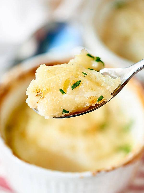 Bite of cheesy potato in spoon