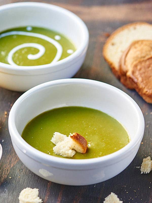 Creamy vegan spinach potato soup in two bowls