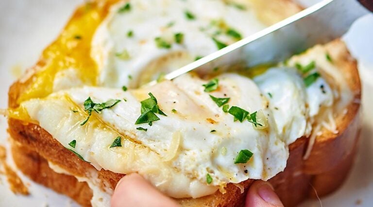 Croque madame sandwich being cut