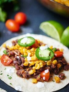 These easy vegan black bean and roasted corn tacos are so good you’ll want them for Meatless Monday and Taco Tuesday! Healthy, filling, and so delicious! showmetheyummy.com #meatlessmonday #vegan #tacotuesday #vegetarian #taco #healthy #glutenfree