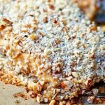 This pecan crusted honey mustard salmon is seriously delicious. The combination of the hearty, yet flakey salmon with the sweet and tangy honey mustard and the toasted and crunchy pecan crust makes for one heckofa dish. It's a perfect, easy weeknight meal that will surely "wow" whoever you serve it to. showmetheyummy.com #healthy #salmon #pecans #honeymustard #seafood