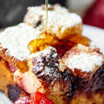 Strawberry Nutella Cream Cheese French Toast Casserole. Thick slices of brioche are smothered in nutella and layered with strawberries and cream cheese. The whole casserole is soaked overnight in a cream, sugar, cinnamon mixture and baked until hot and french toasty! showmetheyummy.com #nutella #strawberry #frenchtoast #casserole #breakfast #creamcheese