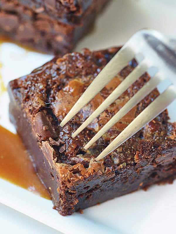 fork in salted caramel brownie above