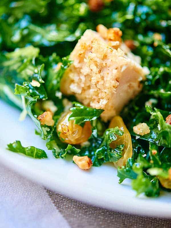 kale salad with baked almond chicken closeup