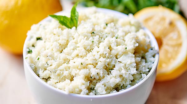 Lemon Garlic Cauliflower Rice. A healthy substitute for rice! It’s naturally gluten free, vegetarian (can be vegan!), and so tasty! Full of fresh lemon juice, basil, garlic, and parmesan cheese. Less than 300 calories for the WHOLE recipe! showmetheyummy.com #glutenfree #healthy #vegetarian #vegan #lightenedup #cauliflower #fresh #rice