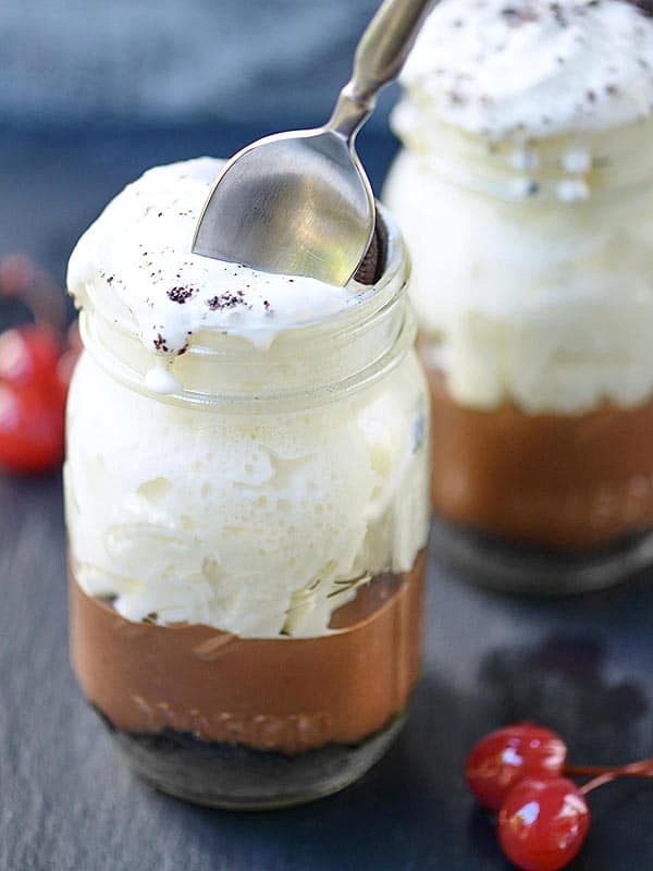 spoon being dipped into jar of pudding