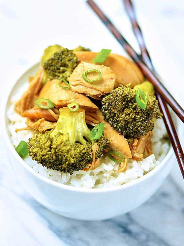 Closeup of chicken, broccoli, rice bowl with chopsticks