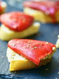 Goat Cheese Stuffed Piquillo Peppers are the perfect tapas! Mild piquillo peppers are stuffed with a goat cheese and manchego filling and paired with a Spanish red wine. showmetheyummy.com #spanish #winepairing #appetizer #vegetarian #goatcheese #tapas #redwine #piquillopeppers