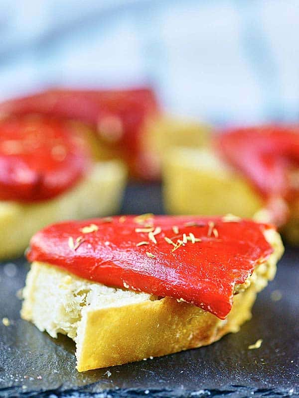 piece of bread with piquillo pepper on baking sheet