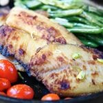 This honey, soy, and garlic tilapia is perfect for a quick and easy weeknight meal! It's healthy, delicious, and comes together in a matter of minutes! showmetheyummy.com #easyrecipes #healthy #honey #soysauce #garlic #tilapia #fish #seafood