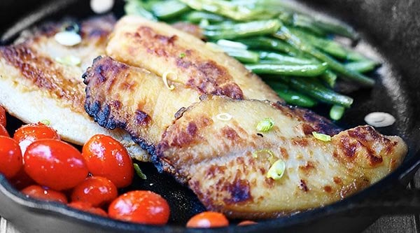 This honey, soy, and garlic tilapia is perfect for a quick and easy weeknight meal! It's healthy, delicious, and comes together in a matter of minutes! showmetheyummy.com #easyrecipes #healthy #honey #soysauce #garlic #tilapia #fish #seafood