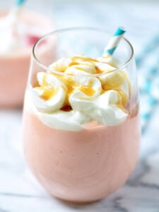 This Tropical Spiked Cake Shake will immediately transport you to some place tropical! It's so thick, creamy, and sweet. It takes like cake batter and is filled with cherries, pineapple, and of course, Malibu Rum! showmetheyummy.com #icecream #milkshake #shake #malibu #rum #tropical #cake #pineapple #coconut #cherries