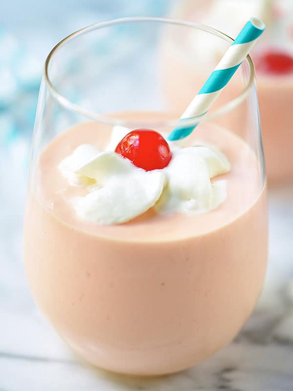 cake shake in cup with cherry, whip, and straw