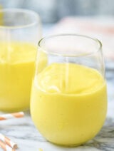 This easy mango smoothie has 5 ingredients and only takes 5 minutes to put together! showmetheyummy.com #mango #smoothie #glutenfree #vegetarian #lemon #breakfast #drinks #greekyogurt