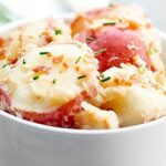 German Potato Salad. Creamy potatoes, crunchy, salty prosciutto, and that perfect tang from the vinegar makes this one of the best potato salads I've ever had! showmetheyummy.com #german #potato #salad #bbq #prosciutto #grilling #sidedish