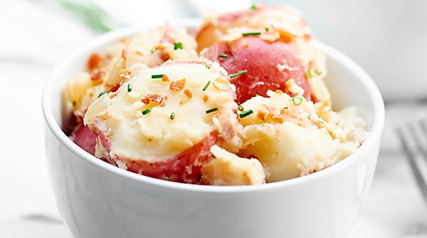 German Potato Salad. Creamy potatoes, crunchy, salty prosciutto, and that perfect tang from the vinegar makes this one of the best potato salads I've ever had! showmetheyummy.com #german #potato #salad #bbq #prosciutto #grilling #sidedish