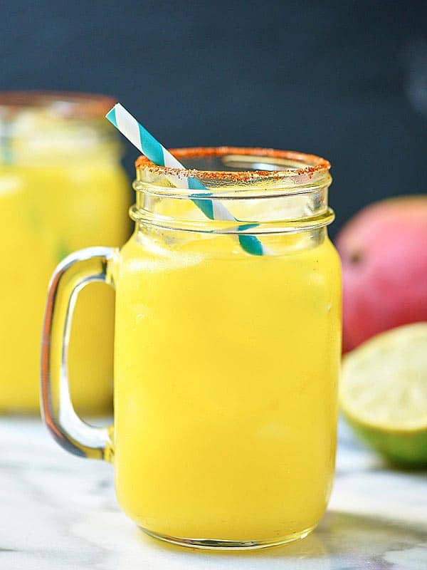 Mango habanero margarita in cup with straw side view