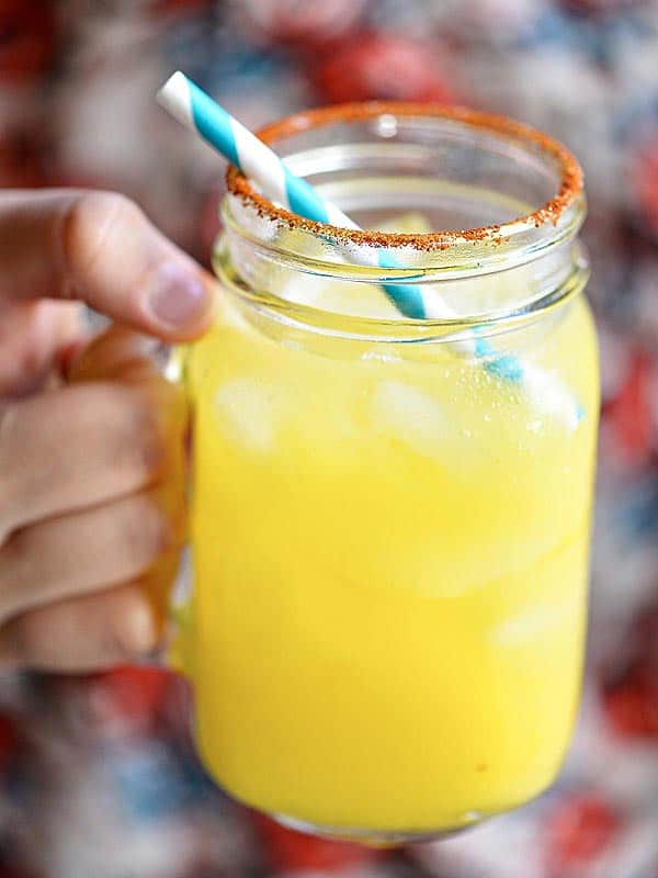 Mason jar with mango habanero margarita held